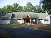 image of the Firefly lodge, showing front porch and road in front