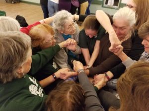 adults attempt to unravel a human knot
